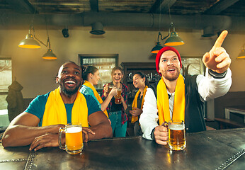 Image showing Sport, people, leisure, friendship and entertainment concept - happy football fans or male friends drinking beer and celebrating victory at bar or pub