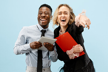 Image showing Concept of partnership in business. Young man and woman standing at studio