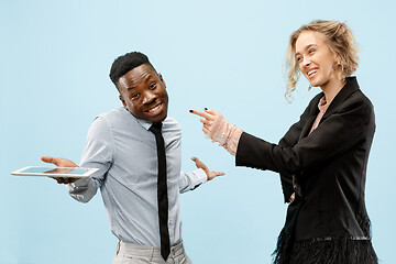 Image showing Concept of partnership in business. Young man and woman standing at studio