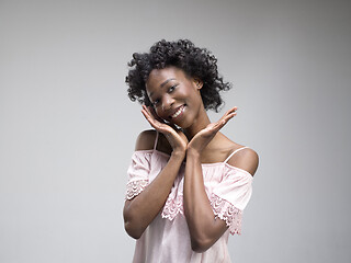 Image showing The happy african woman standing and smiling against gray background.