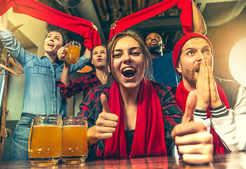 Image showing Sport, people, leisure, friendship and entertainment concept - happy football fans or male friends drinking beer and celebrating victory at bar or pub