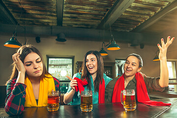 Image showing Sport, people, leisure, friendship and entertainment concept - happy football fans or female friends drinking beer and celebrating victory at bar or pub