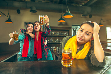 Image showing Sport, people, leisure, friendship and entertainment concept - happy football fans or female friends drinking beer and celebrating victory at bar or pub