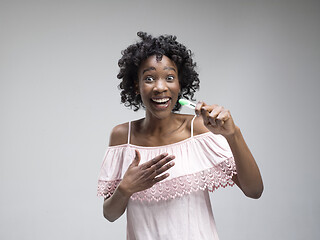 Image showing Smiling young woman looking on pregnancy test