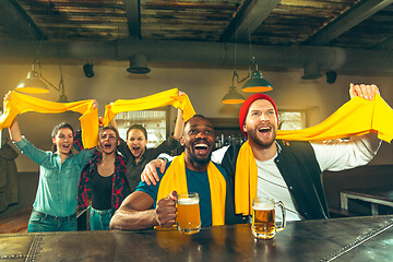 Image showing Sport, people, leisure, friendship and entertainment concept - happy football fans or male friends drinking beer and celebrating victory at bar or pub