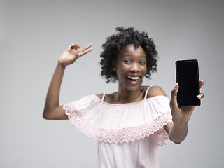 Image showing Portrait of a confident casual afro girl showing blank screen mobile phone