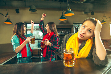 Image showing Sport, people, leisure, friendship and entertainment concept - happy football fans or female friends drinking beer and celebrating victory at bar or pub