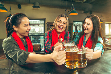 Image showing Sport, people, leisure, friendship and entertainment concept - happy football fans or female friends drinking beer and celebrating victory at bar or pub