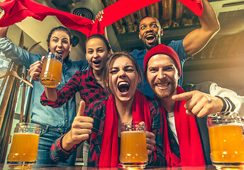 Image showing Sport, people, leisure, friendship and entertainment concept - happy football fans or male friends drinking beer and celebrating victory at bar or pub