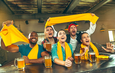 Image showing Sport, people, leisure, friendship and entertainment concept - happy football fans or male friends drinking beer and celebrating victory at bar or pub