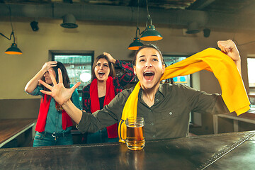 Image showing Sport, people, leisure, friendship and entertainment concept - happy football fans or female friends drinking beer and celebrating victory at bar or pub