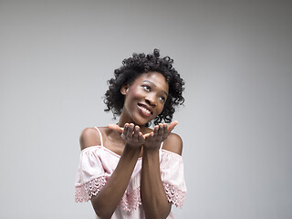 Image showing The happy african woman standing and smiling against gray background.