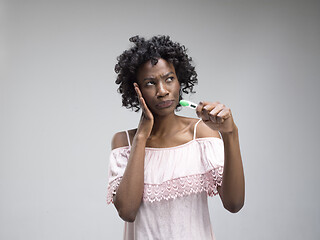 Image showing young woman looking on pregnancy test