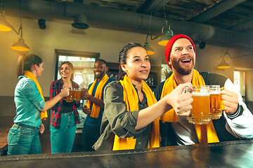 Image showing Sport, people, leisure, friendship and entertainment concept - happy football fans or male friends drinking beer and celebrating victory at bar or pub