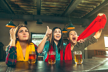 Image showing Sport, people, leisure, friendship and entertainment concept - happy football fans or female friends drinking beer and celebrating victory at bar or pub