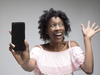 Image showing Portrait of a confident casual afro girl showing blank screen mobile phone