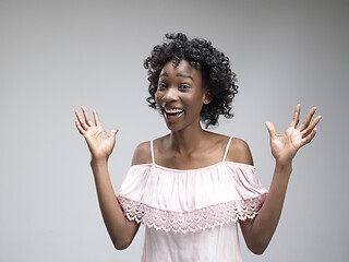 Image showing Winning success woman happy ecstatic celebrating being a winner. Dynamic energetic image of female afro model