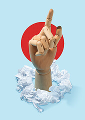 Image showing Concept of a new idea. A wooden hand and crumpled pieces of paper