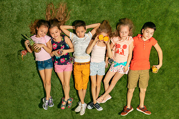 Image showing Group of happy children playing outdoors.