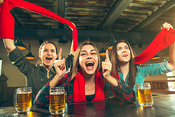 Image showing Sport, people, leisure, friendship and entertainment concept - happy football fans or female friends drinking beer and celebrating victory at bar or pub