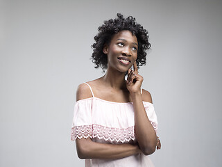 Image showing The happy african woman standing and smiling against gray background.