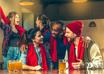 Image showing Sport, people, leisure, friendship and entertainment concept - happy football fans or male friends drinking beer and celebrating victory at bar or pub