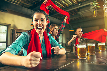 Image showing Sport, people, leisure, friendship and entertainment concept - happy football fans or female friends drinking beer and celebrating victory at bar or pub