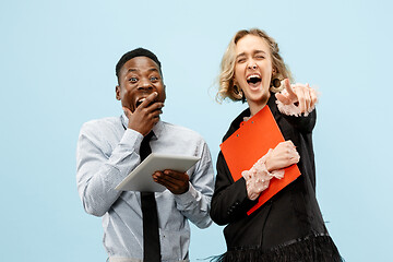 Image showing Concept of partnership in business. Young man and woman standing at studio