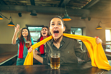 Image showing Sport, people, leisure, friendship and entertainment concept - happy football fans or female friends drinking beer and celebrating victory at bar or pub