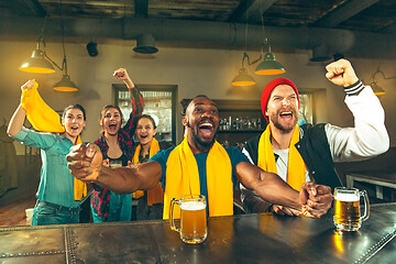 Image showing Sport, people, leisure, friendship and entertainment concept - happy football fans or male friends drinking beer and celebrating victory at bar or pub