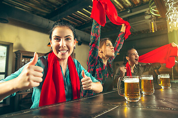 Image showing Sport, people, leisure, friendship and entertainment concept - happy football fans or female friends drinking beer and celebrating victory at bar or pub