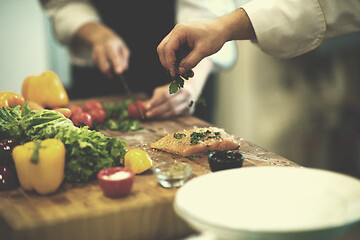 Image showing Chef hands preparing marinated Salmon fish