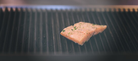 Image showing Salmon fillets cooking on grill