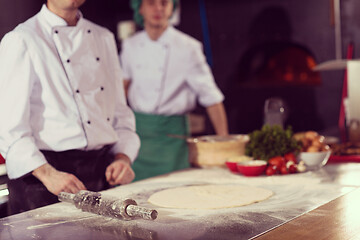 Image showing chef preparing dough for pizza