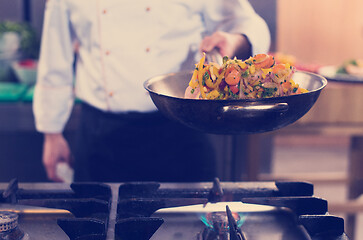 Image showing chef flipping vegetables in wok