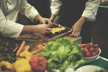 Image showing team cooks and chefs preparing meal