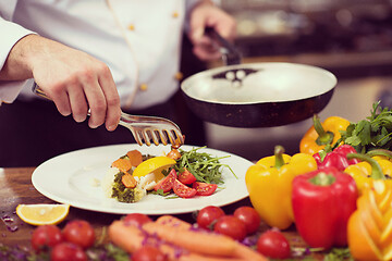 Image showing chef serving vegetable salad