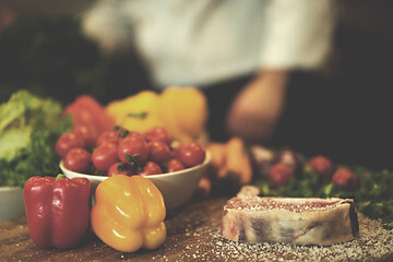 Image showing Juicy slice of raw steak on wooden table