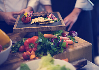 Image showing team cooks and chefs preparing meal