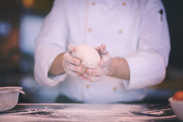 Image showing chef hands preparing dough for pizza