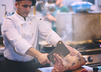 Image showing chef cutting big piece of beef