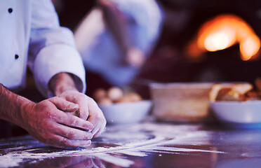 Image showing chef hands preparing dough for pizza