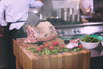 Image showing chef cutting big piece of beef