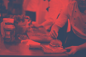 Image showing chef finishing burger