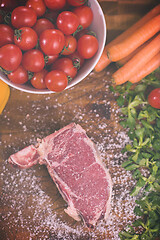 Image showing top view of raw steak on wooden table