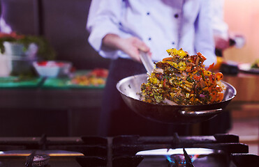 Image showing chef flipping vegetables in wok