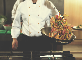 Image showing chef flipping vegetables in wok