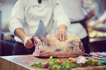 Image showing chef cutting big piece of beef