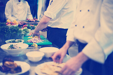 Image showing team cooks and chefs preparing meal