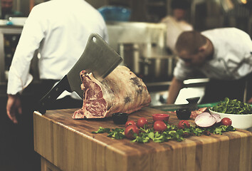 Image showing chef cutting big piece of beef